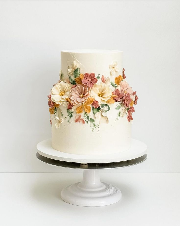 there is a white cake with flowers on it