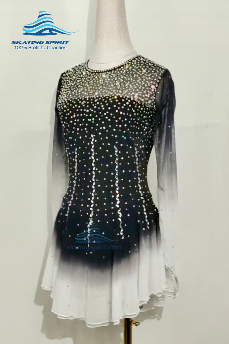 a black and white dress with silver sequins on the top, sitting on a mannequin