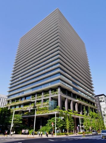 an office building with plants growing on the side