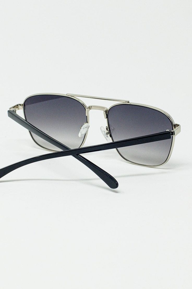 The Squared Metal Sunglasses in Gray Smoke Lens offer a sleek and contemporary look with their bold squared design. Featuring a sophisticated silver metal frame, these sunglasses are both stylish and durable, ensuring they not only look great but also stand up to everyday wear.  The gray smoked lenses add a touch of mystery and elegance while providing effective sun protection and reducing glare. These sunglasses are perfect for adding a modern edge to any outfit, whether you're heading out for a casual day or dressing up for a special occasion.  The model, with measurements of 33 inches at the bust, 25 inches at the waist, and 35 inches at the hips, stands 5'9" tall and is wearing size U. These squared metal sunglasses are designed to fit comfortably and provide a chic, understated comple Trendy Silver Sunglasses With Gradient Lenses, Sleek Silver Sunglasses For Summer, Trendy Silver Sunglasses With Metal Frame, Trendy Silver Aviator Sunglasses, Classic Metal Sunglasses With Mirrored Lenses, Trendy Silver Aviator Sunglasses With Uva Protection, Trendy Silver Rectangular Sunglasses, Trendy Silver Aviator Sunglasses With Metal Frame, Classic Silver Sunglasses With Uva Protection