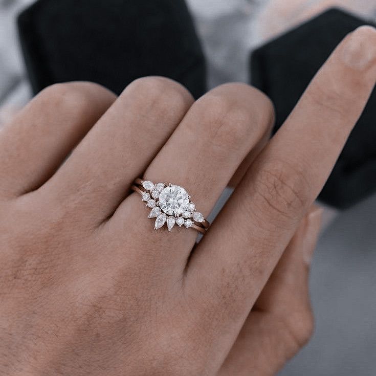 a woman's hand with a diamond ring on it