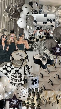 a room filled with lots of black and white balloons