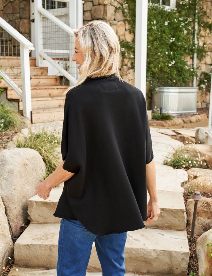 This airy capelet is perfect for those hint-of-spring days: sleeveless to catch the breeze and relaxed in fit with a gently-rolled funnel neck that adds a pop of polish to any look. This capelet top effortlessly combines style and comfort. Chic Black Cape For Spring, Spring Layering Cape, Casual High Neck Outerwear For Spring, Spring Black Outerwear With Batwing Sleeves, Spring Black Batwing Sleeve Outerwear, Oversized Chic Cape For Spring, Spring High Neck Outerwear For Layering, Chic Oversized Cape For Spring, Spring Poncho Cape For Layering