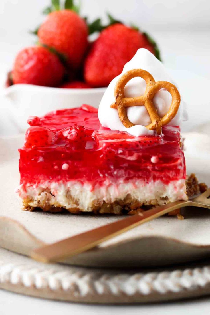 a slice of strawberry cheesecake with pretzels on top