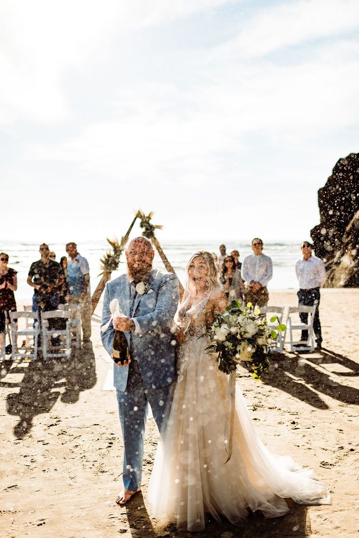 a bride and groom walking down the aisle after their wedding ceremony at the beach in santa cruz, california