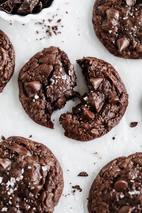 chocolate cookies with sea salt sprinkled on the top and one broken in half