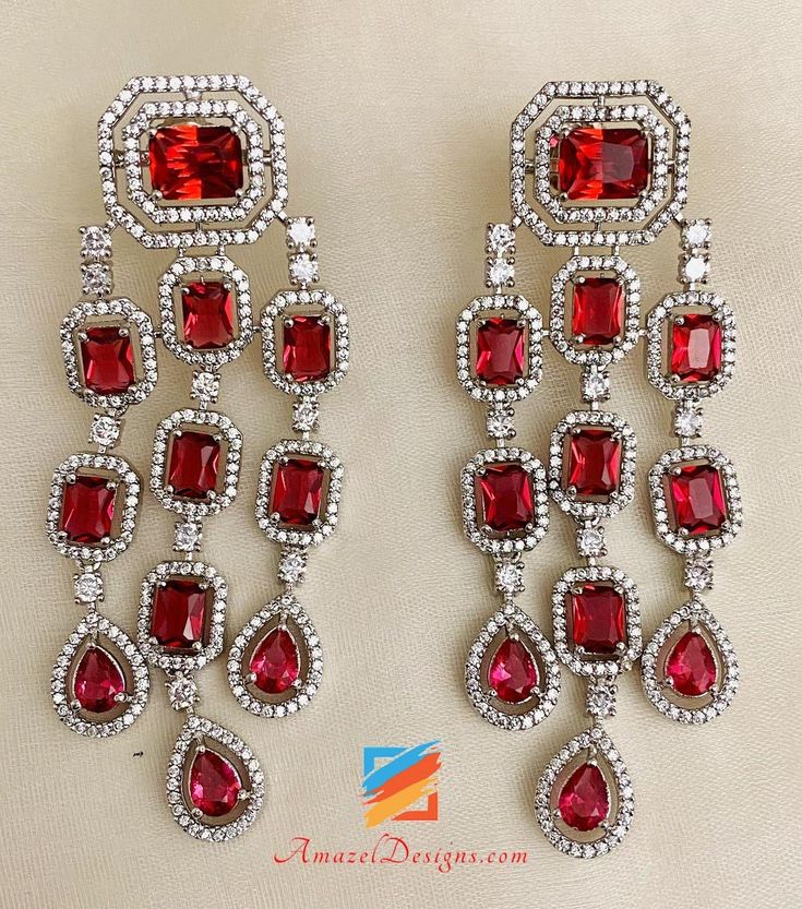 Red Mehroon American Diamond (AD) Earrings. Available to shop online and delivered to your doorsteps anywhere in the world with our Everything-Everywhere FREE Shipping. 📦Unmatched FREE Worldwide Shipping EXPLORE more Indian Earrings and Jhumki Earrings. Maang Tikka Sets and Tikka Set Punjabi AMERICAN DIAMOND JEWELLERY Match with our pretty Single Line Necklaces Deepika, USA ⭐️⭐️⭐️⭐️⭐️ Thank you Thank you Thank you!! If I fell in love with the pictures, then I’m absolutely floored after seeing t Luxury Bollywood Bridal Earrings With American Diamonds, Festive Red Drop Earrings, Red Drop Earrings Danglers For Wedding, Red Dangle Earrings For Festive Occasions, Red Festive Dangle Earrings, Red Drop Danglers For Wedding, Red Ruby Dangle Chandelier Earrings, Red Ruby Danglers, Red Drop Danglers For Festive Occasions