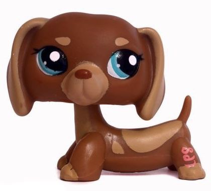 littlest pet shop puppy dog with blue eyes and brown body sitting on the ground