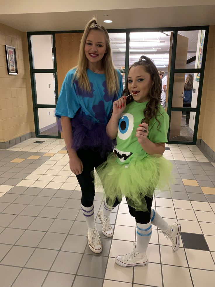 two girls in costumes standing next to each other