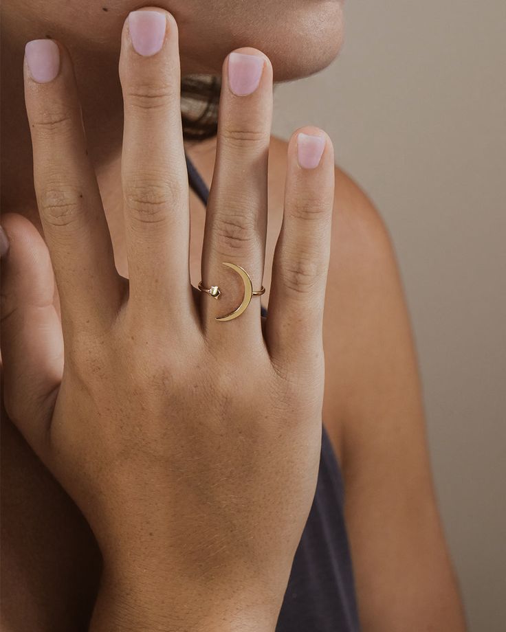 Want to capture the beauty of the moon and stars for yourself? This open ring is exactly what you need! This smooth, sleek ring is made of sturdy sterling silver. You'll be sure to shine just like a star when you're wearing this! Materials: 14K gold plated sterling silver or sterling silver Features: 1mm band, 4mm star, 17mm crescent moon, Lead & Nickel free, open band- allows for minor adjustments Minimalist Crescent Moon Charm Ring, Celestial Open Ring With Moon Charm, Minimalist Adjustable Rings With Moon Charm, Minimalist Adjustable Ring With Moon Charm, Moonstone Open Ring With Moon Phase Detail, Dainty Jewelry Open Ring With Moon Phase, Gold Minimalist Rings With Moon Phase, Minimalist Gold Rings With Moon Phase, Dainty Moon Phase Open Ring Jewelry