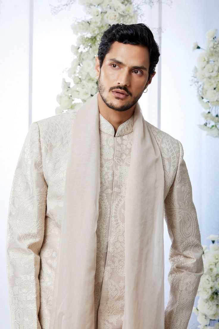 This sherwani set features all over matt sequin on a sand raw silk base. It is paired with off-white silk kurta and soften raw silk afghani salwar. Complimenting stole and footwear is also available.From Seema Gujral's Tuscan Summer collection. DELIVERY TIMEPlease allow 8-12 weeks for your outfit to arrive.FABRIC DETAILSRaw SilkProfessional cleaning only. Festive Cream Kurta With Sheer Dupatta, Traditional Cream Churidar With Sheer Dupatta, Traditional Beige Wear With Sheer Dupatta, Beige Traditional Wear With Sheer Dupatta, Eid Cream Traditional Wear With Sheer Dupatta, Elegant Sherwani With Sheer Dupatta For Eid, Elegant Beige Raw Silk Churidar, Elegant Sherwani With Sheer Dupatta For Diwali, Elegant Sherwani With Sheer Dupatta