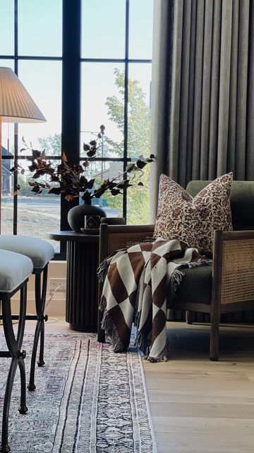 a living room filled with furniture and large windows