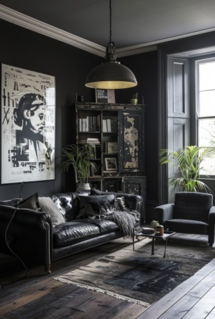 a living room with black walls and leather furniture