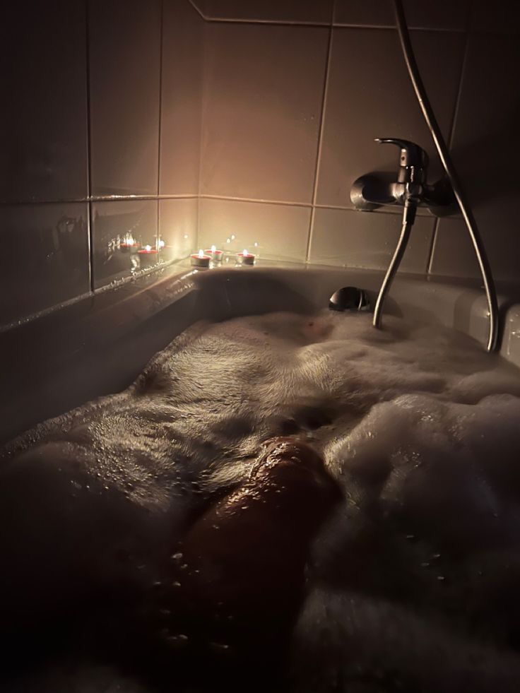 a bathtub filled with foam and water at night