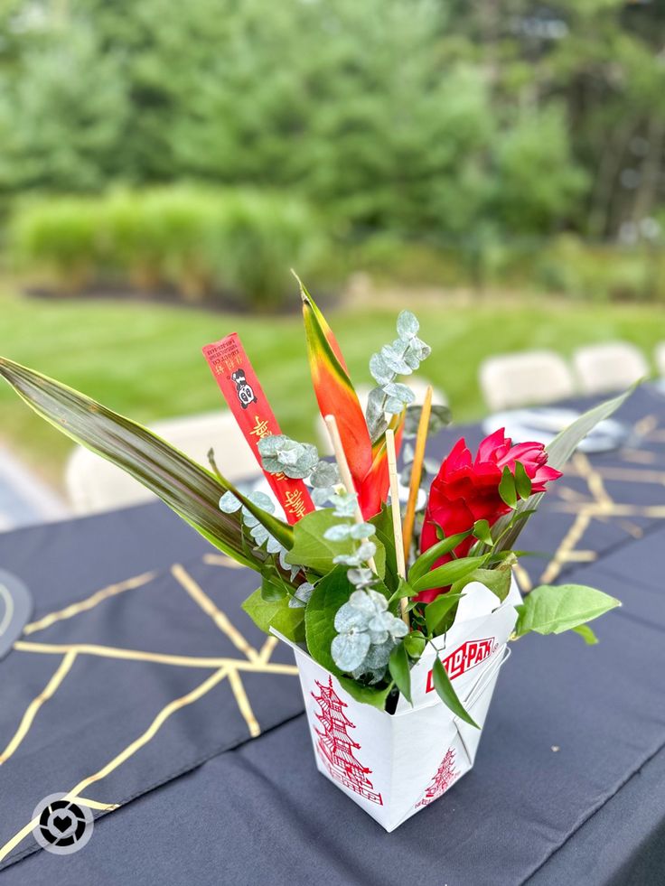 a bouquet of flowers in a paper bag on a table