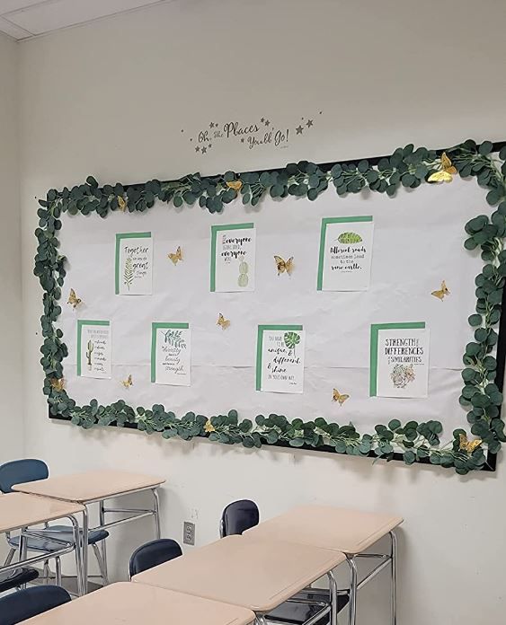 an empty classroom with desks and chairs in front of a bulletin board that has butterflies on it