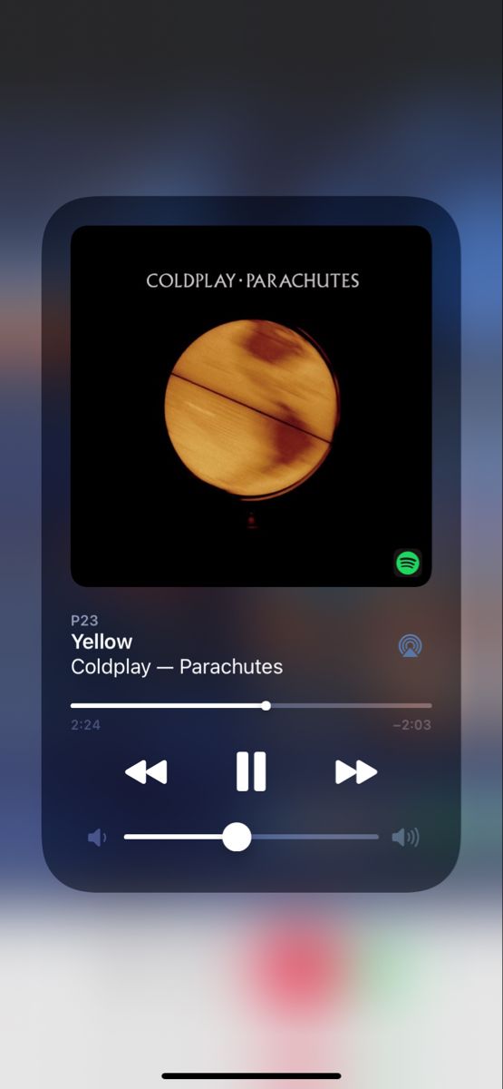 an iphone screen with the text coldplay - parachutes on it and music player in the background