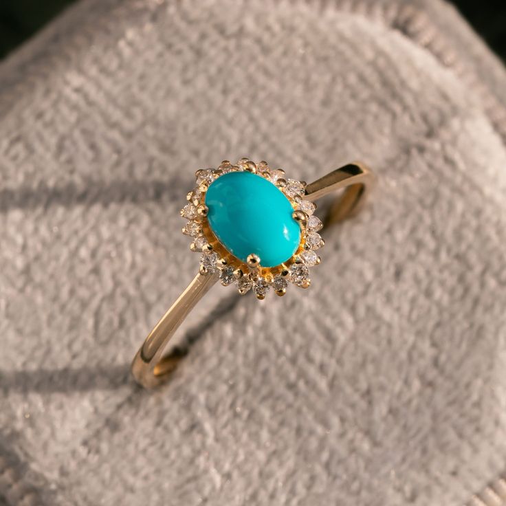 Natural Blue Turquoise Engagement Ring in 14k Yellow Gold/Oval Turquoise with Diamond Halo/Unique Engagement Ring/Gift For Her/Bridal Ring ★ ★ ★ ★  CUSTOM/DUTY-FREE SHIPPING WORLDWIDE, BUYERS DON'T HAVE TO PAY ANY CUSTOM FEES WHILE IMPORTING ★ ★ ★ ★  Details Made to order Material: 14k/18k gold Color Options: Yellow Gold, White Gold, Rose Gold ★ Center Stone Turquoise, Oval Cab Size: 5X7 mm Approx Weight (Ct): 0.96 ★ Accent Stones Diamond/Moissanite Round Size: 1.1 mm * 16 No.s , 1.5 mm * 4 Nos. Approx Weight (Ct): 0.15 ★ Band Width: 1.3 mm ★ Ring Height: 7 mm Procedure information ★ 100% Natural Diamond and Gemstones ★ Diamond: Round Brilliant cut, G-H Color, SI Clarity ☂ Shipped with Insured Shipping within 4-7 business days. ➦ 100% Free Returns. ➦ Our Jewelry comes with a Lifetime Warra Luxury Diamond Turquoise Ring For Gift, Cheap Oval Turquoise Ring, Cheap Oval Turquoise Ring For Gift, Luxury Turquoise Ring With Diamond Accents As A Gift, Luxury Turquoise Diamond Ring, Elegant Style, Luxury Diamond Turquoise Ring In Elegant Style, Luxury Vintage Turquoise Engagement Ring, Luxury Classic Turquoise Engagement Ring, Turqiouse Engagement Ring