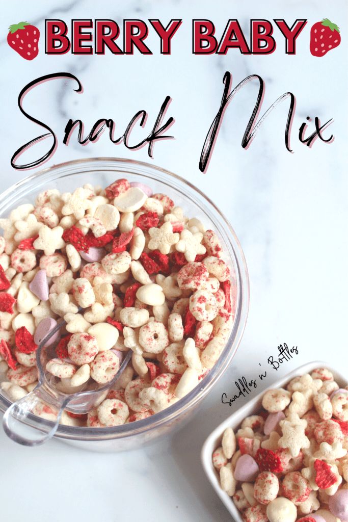 a bowl full of snack mix next to a container with strawberries on it and the words berry baby snack mix