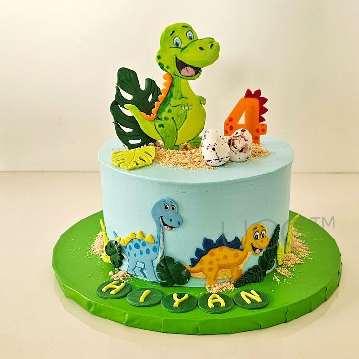 a dinosaur themed birthday cake on a green plate