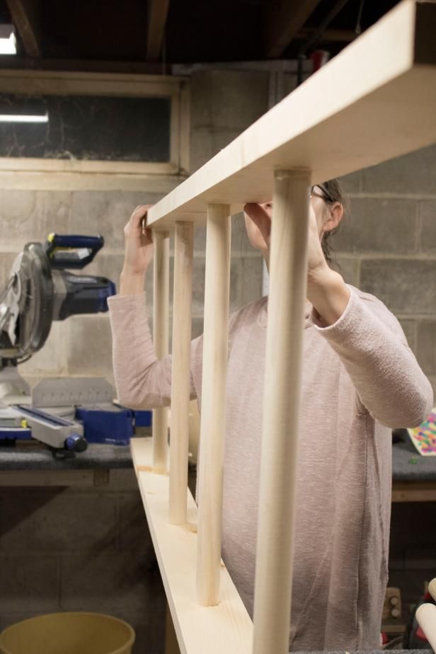 a woman is working on a piece of wood