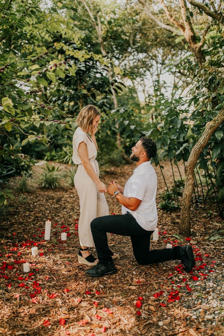 a man kneeling down next to a woman