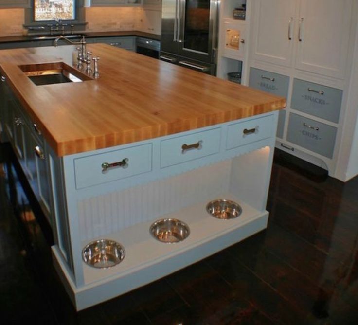 a large kitchen with an island in the middle