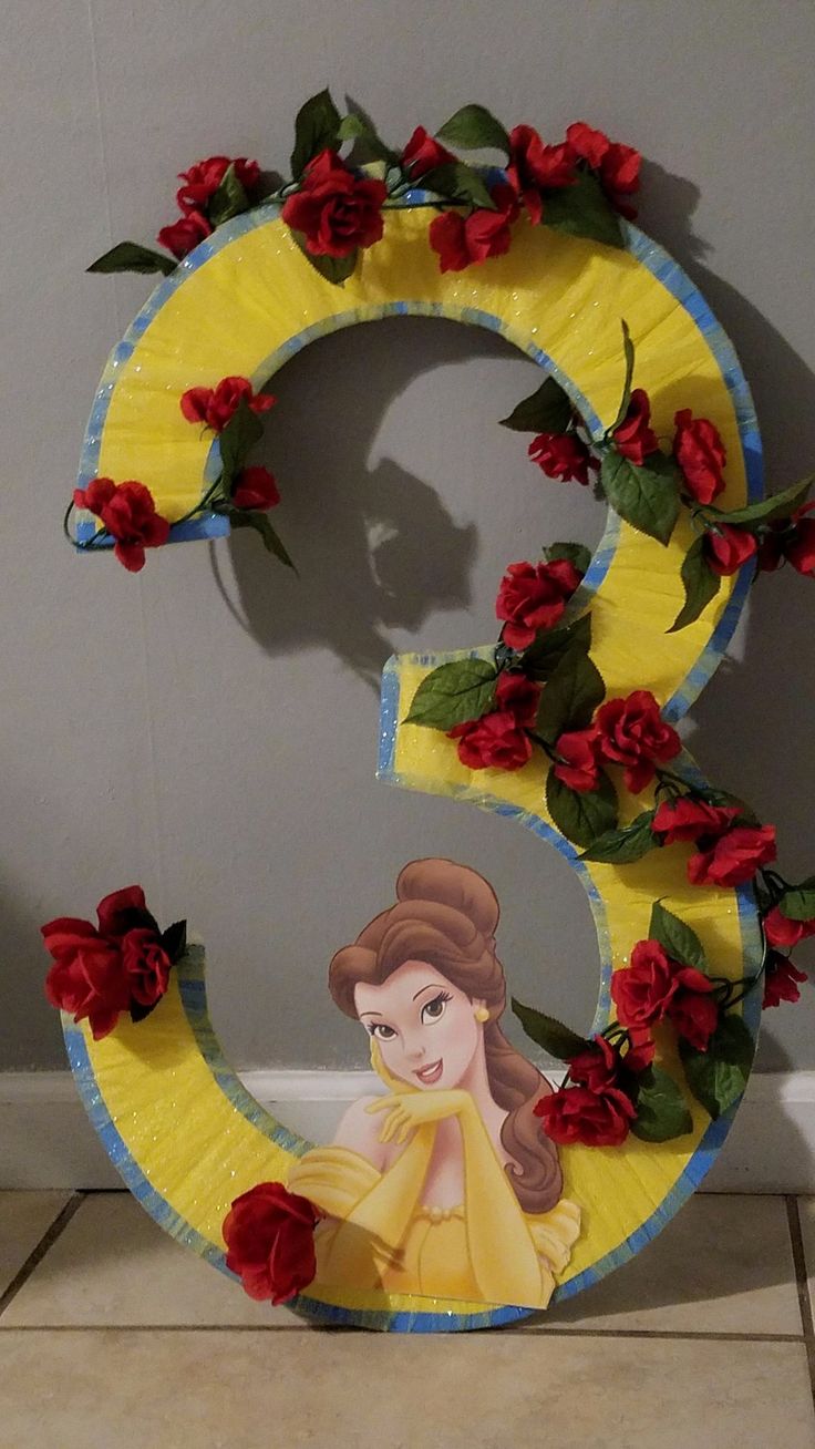 the number three is decorated with red roses and has an image of princess on it