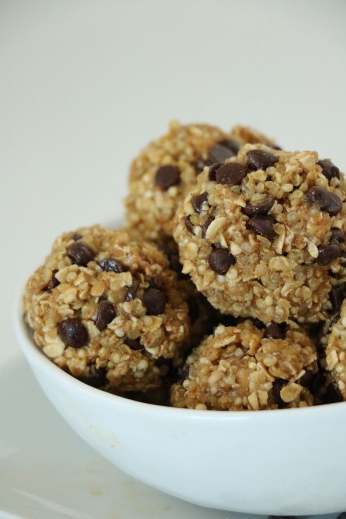 a bowl filled with oatmeal and chocolate chip granola balls on top of a table