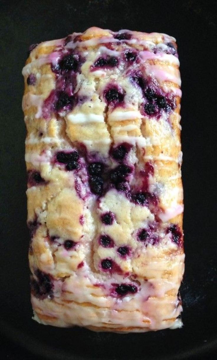 a close up of a pastry with blueberries on it