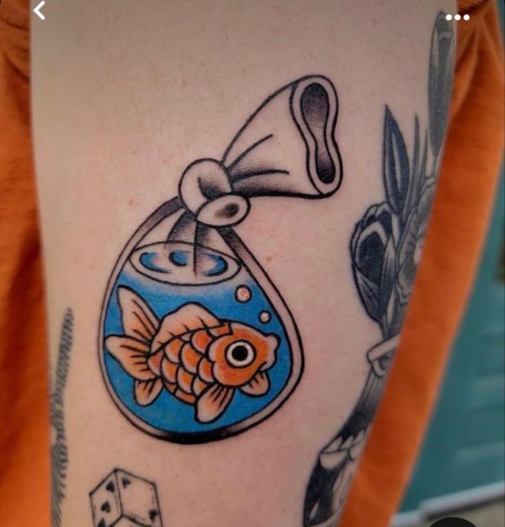 a woman with a tattoo on her arm has a goldfish in a fish bowl