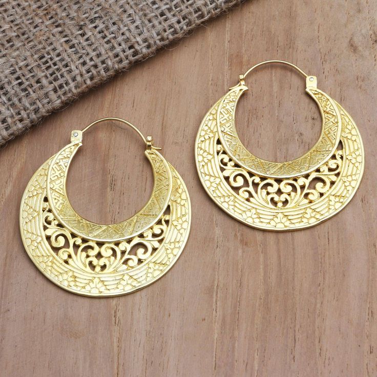 Dewa Nyoman Oka in Bali uses shimmering gold crescents to create his twist on the classic hoop earring. Perfect for formal occasions the earrings are crafted from 18k gold-plated brass before being engraved with elaborate designs and polished for a ravishing shine. Slytherin Jewelry, Small Earrings Gold, Sweet Accessories, Handmade Silver Jewellery, Brass Hoop Earrings, Black Beaded Jewelry, Bangle Bracelet Set, Brass Hoops, Fancy Jewellery