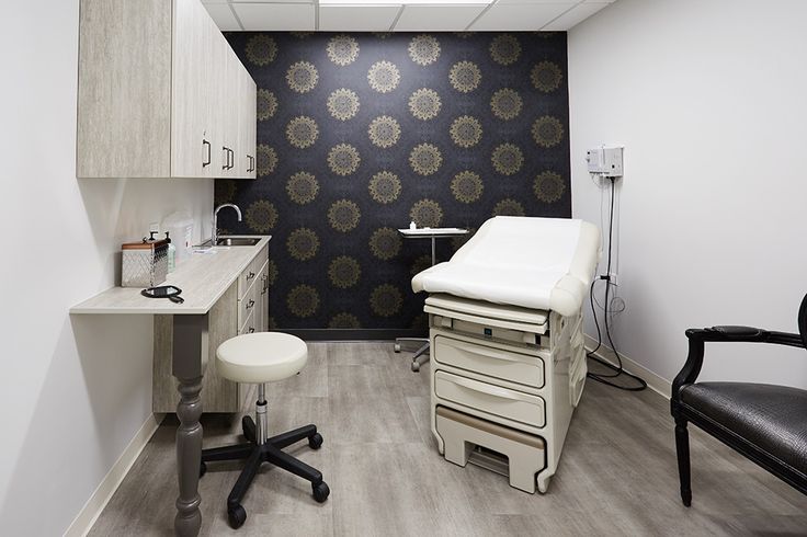 a room with a chair, sink and other medical equipment