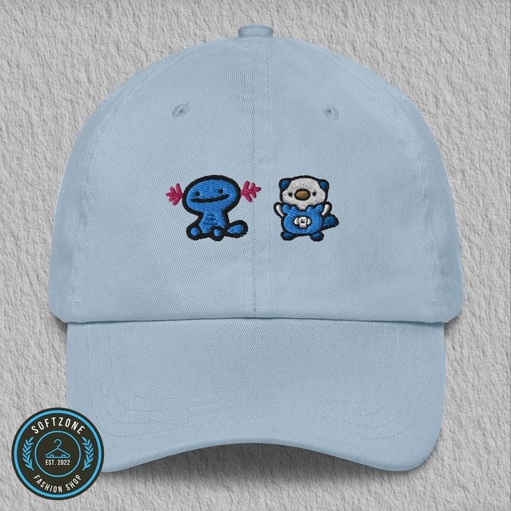 a light blue hat with two cartoon characters on the front and one is embroidered onto it