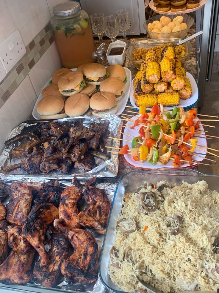 various foods are displayed on trays in a buffet