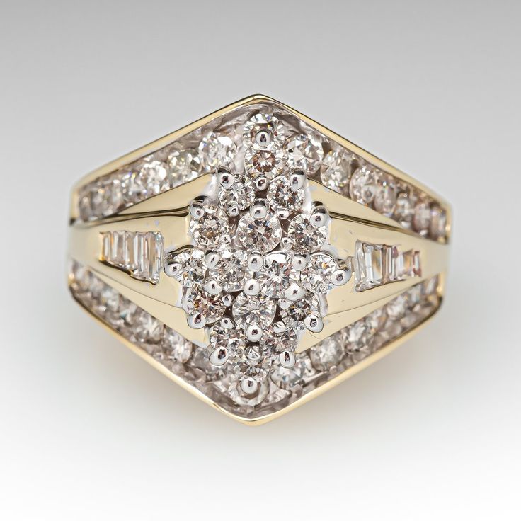 This elegant ring is centered with a cluster setting accented with forty-six (46), prong set, round brilliant cut diamonds. The ring is also accented with thirty (30), bead set, round brilliant cut diamonds and twelve (12), channel set, baguette cut diamonds. The ring measures 10.8mm at the top, rises 4.9mm above the finger, tapering to 4.2mm wide and 1.1mm thick at the base of the shank. This ring is currently a size 7.25. Cluster Pave Setting Promise Ring, Cluster Ring With Single Cut Diamonds In Cubic Zirconia, Cluster Ring With Pave Setting For Promise, Cubic Zirconia Cluster Ring With Single Cut Diamonds, Fine Jewelry Diamond Ring With Single Cut Cluster, Dazzling Diamond Cut Cluster Ring, Diamond White Cluster Halo Ring, Dazzling Diamond Cluster Ring With Single Cut Diamonds, Dazzling Cluster Diamond Ring With Single Cut Diamonds