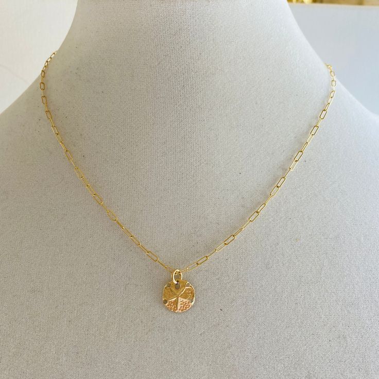 A sand dollar coin dangles from a delicate gold chain. The chain measures approximately 17 inches long is adjustable up to an inch shorter. Delicate Charm Necklace With Coin Pendant, Dainty Charm Necklaces With Coin Pendant, Dainty Chain Necklace With Coin Pendant, Dainty Coin Pendant Charm Necklace, Dainty Adjustable Charm Necklace With Coin Pendant, 14k Gold Filled Charm Necklace With Coin Pendant, Dainty Medallion Necklace With Adjustable Chain, Dainty Medallion Necklace With Delicate Chain, Dainty Coin Necklace With Delicate Chain And Round Pendant