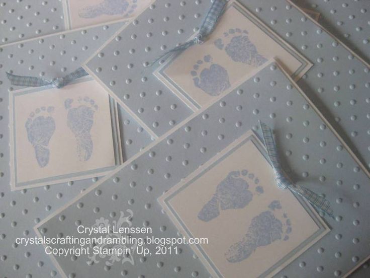 several baby footprints are placed on top of each other with blue ribbon around the edges