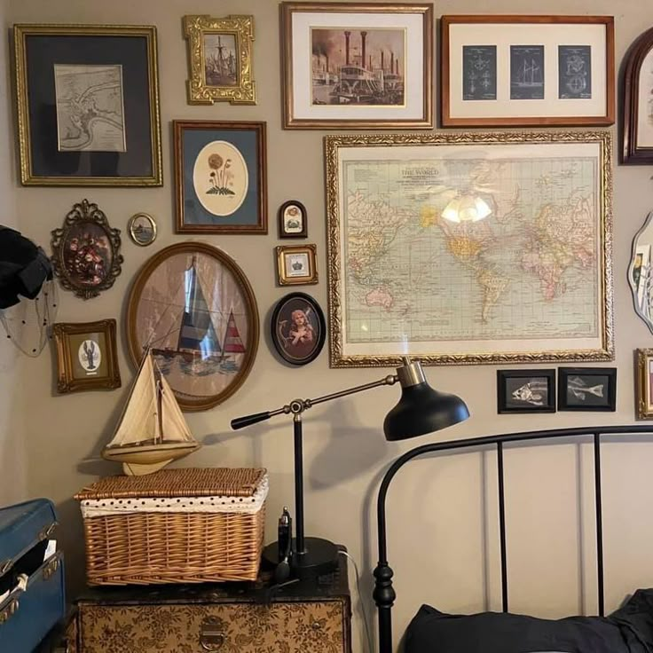 a bed room with a neatly made bed and lots of framed pictures on the wall