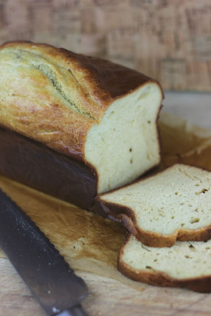 a loaf of bread sitting on top of a cutting board next to a knife