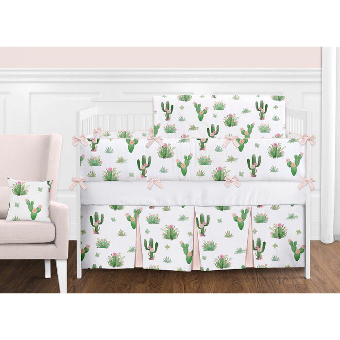 a baby crib bedding set with pink and green cactus print