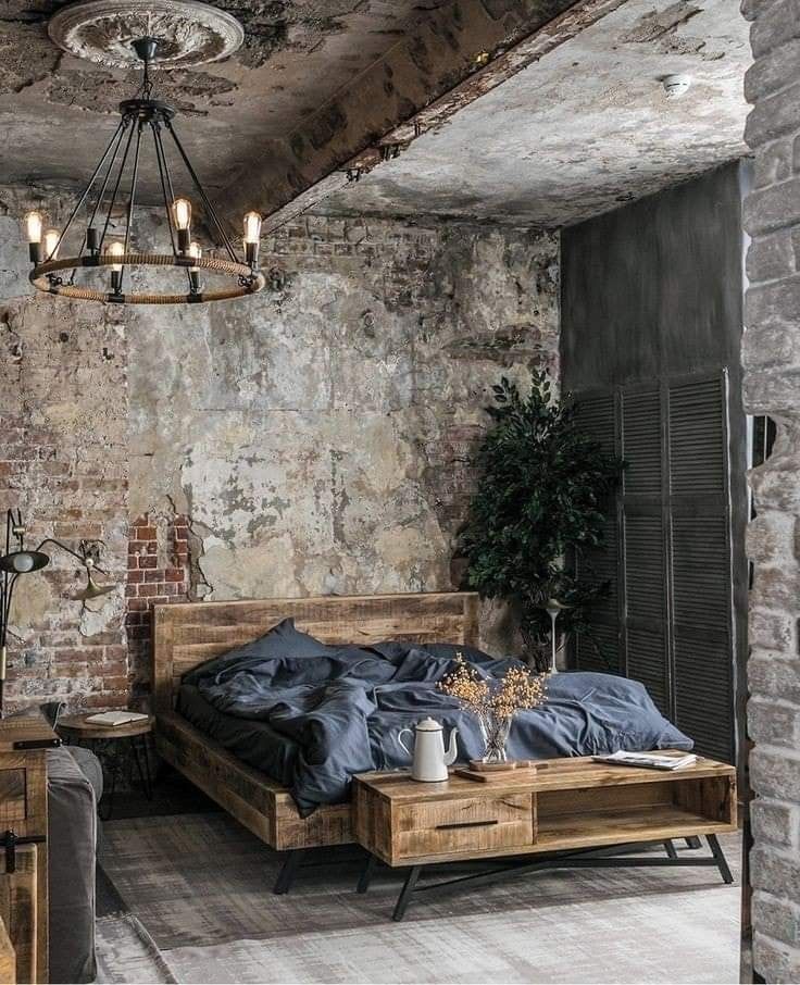 a bedroom with brick walls and exposed ceilings