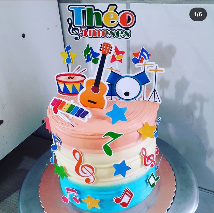 there is a colorful cake with musical instruments on it and the words theeo sings