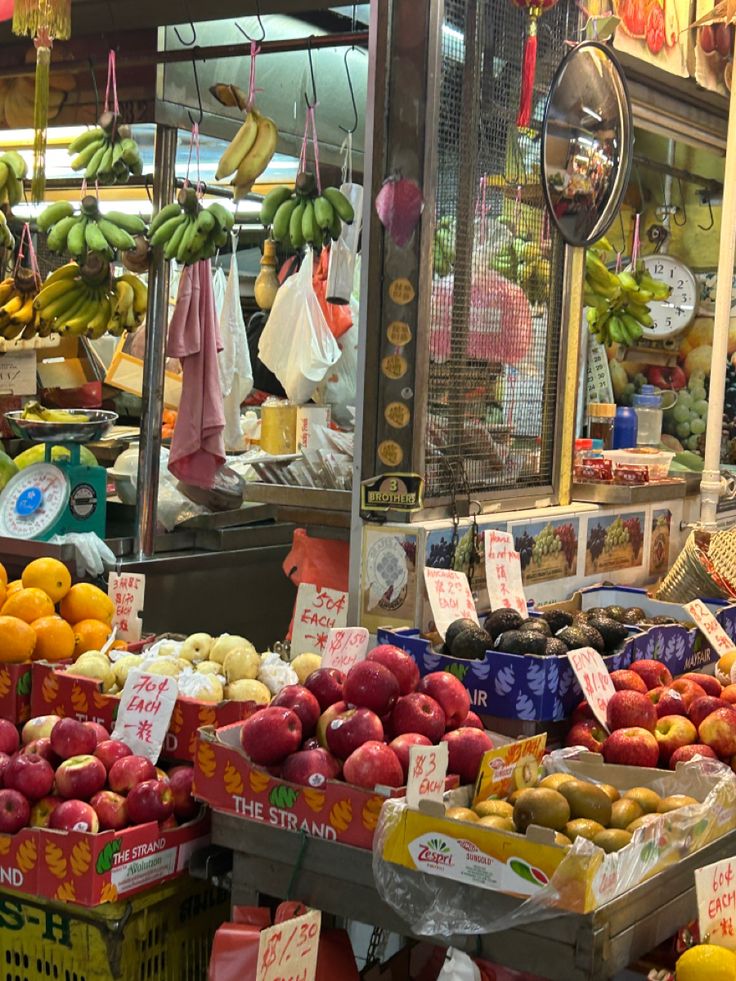 the fruit stand has many different types of fruits and vegetables on display for sale at the market