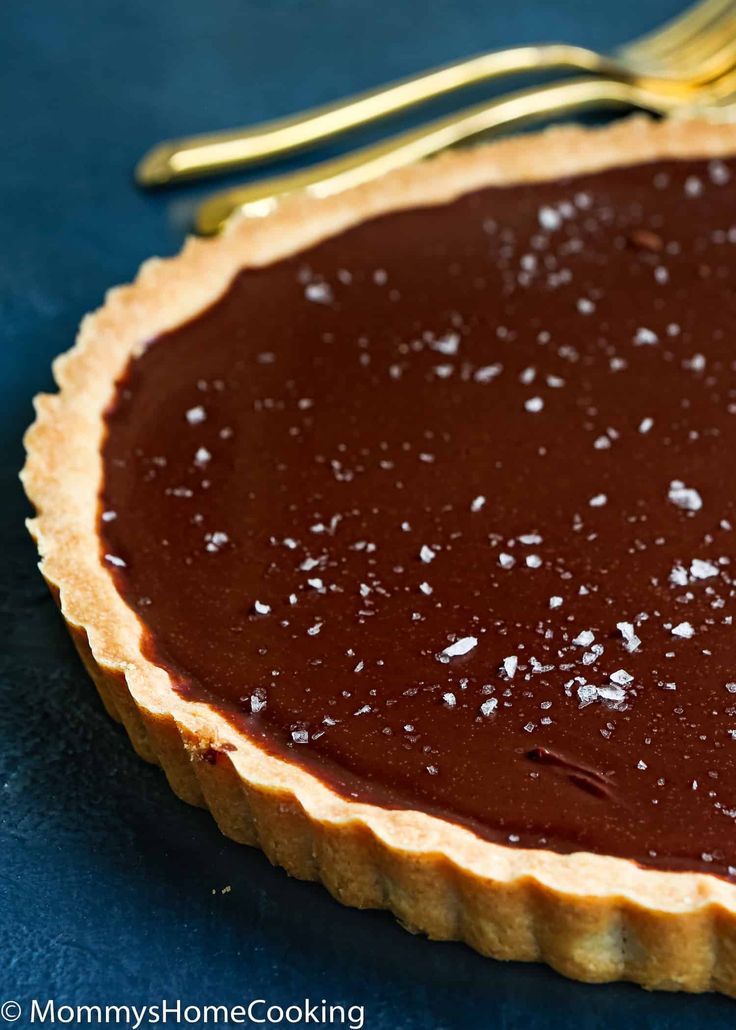 a chocolate pie sitting on top of a blue table