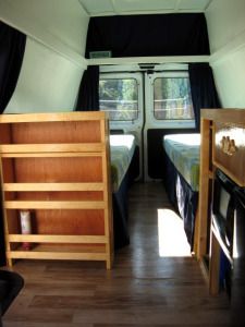 the interior of a small camper with two beds