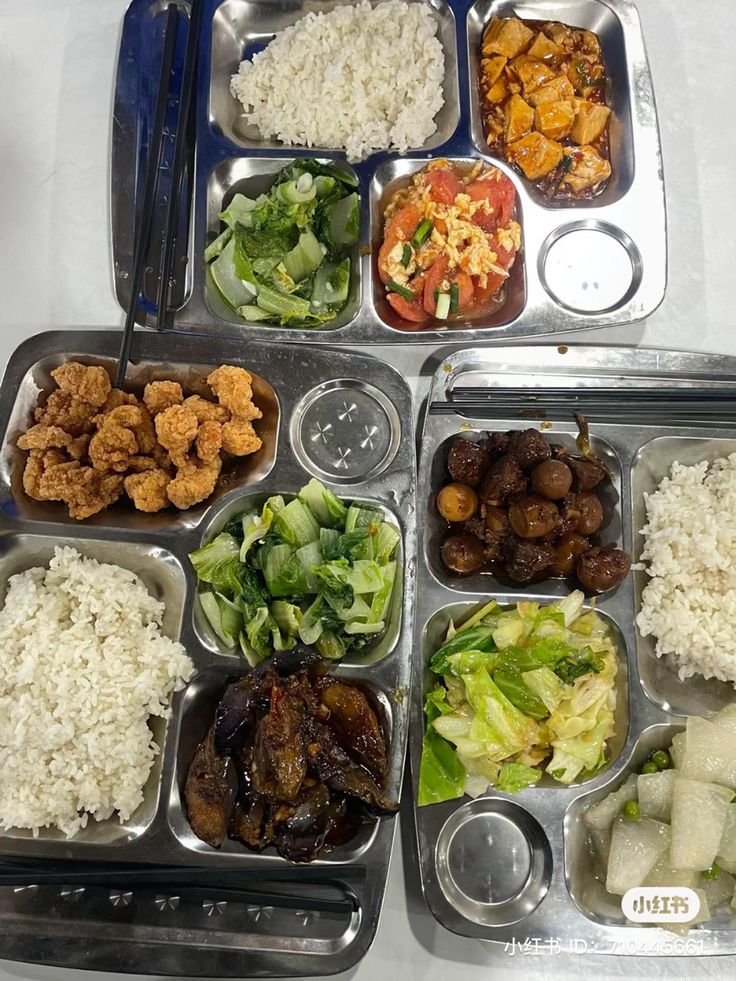 an assortment of food items in trays on a table