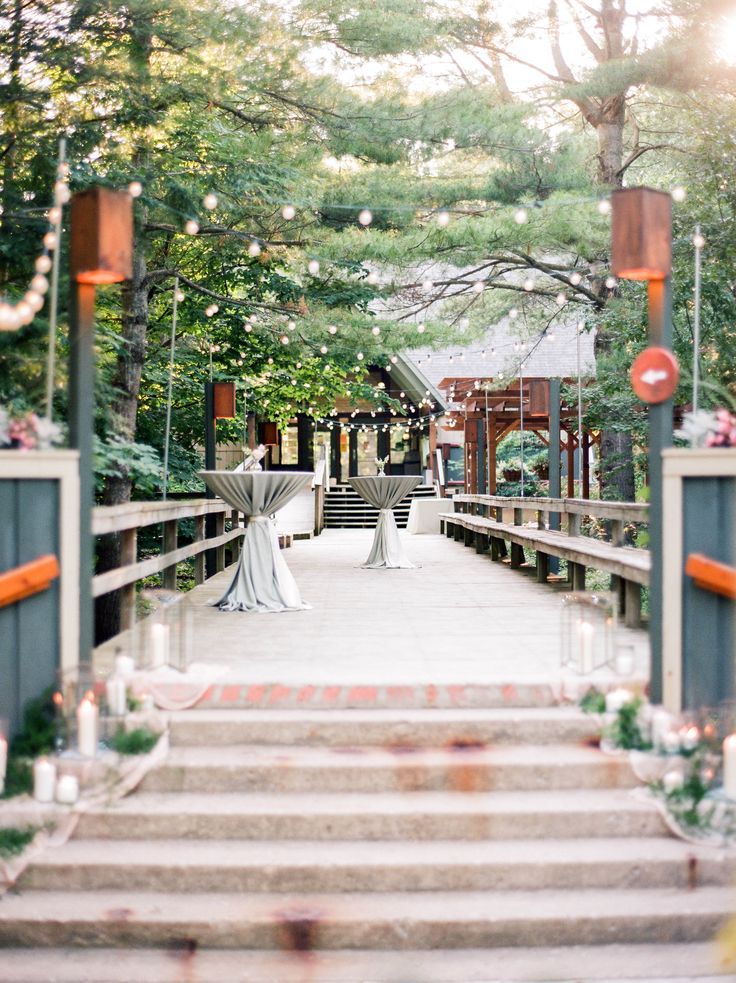 an outdoor wedding venue with stairs leading up to the ceremony room and table set up