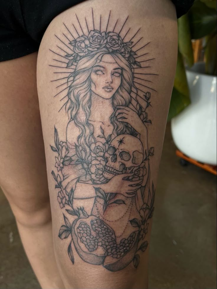 a woman's thigh with a tattoo on it