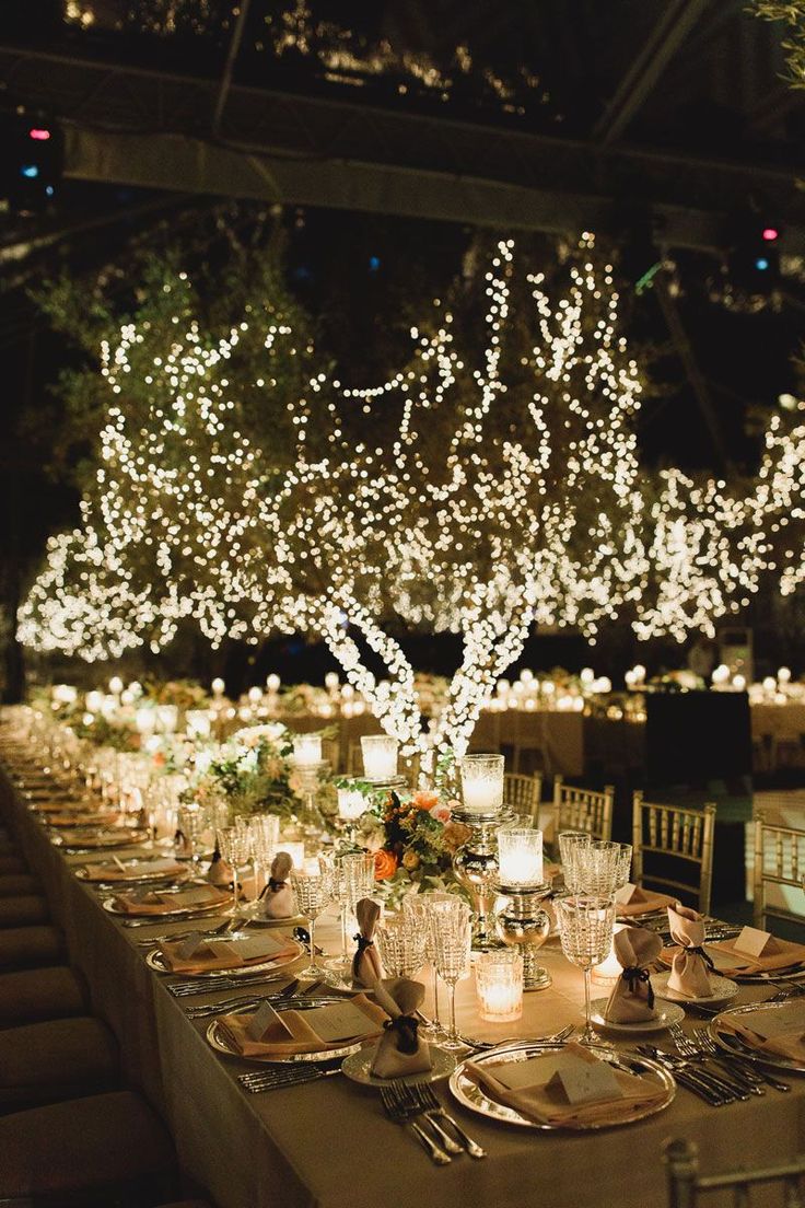 a long table is set with candles and place settings for an elegant dinner or party